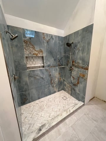 Modern blue tile shower installation by Alliance Construction.